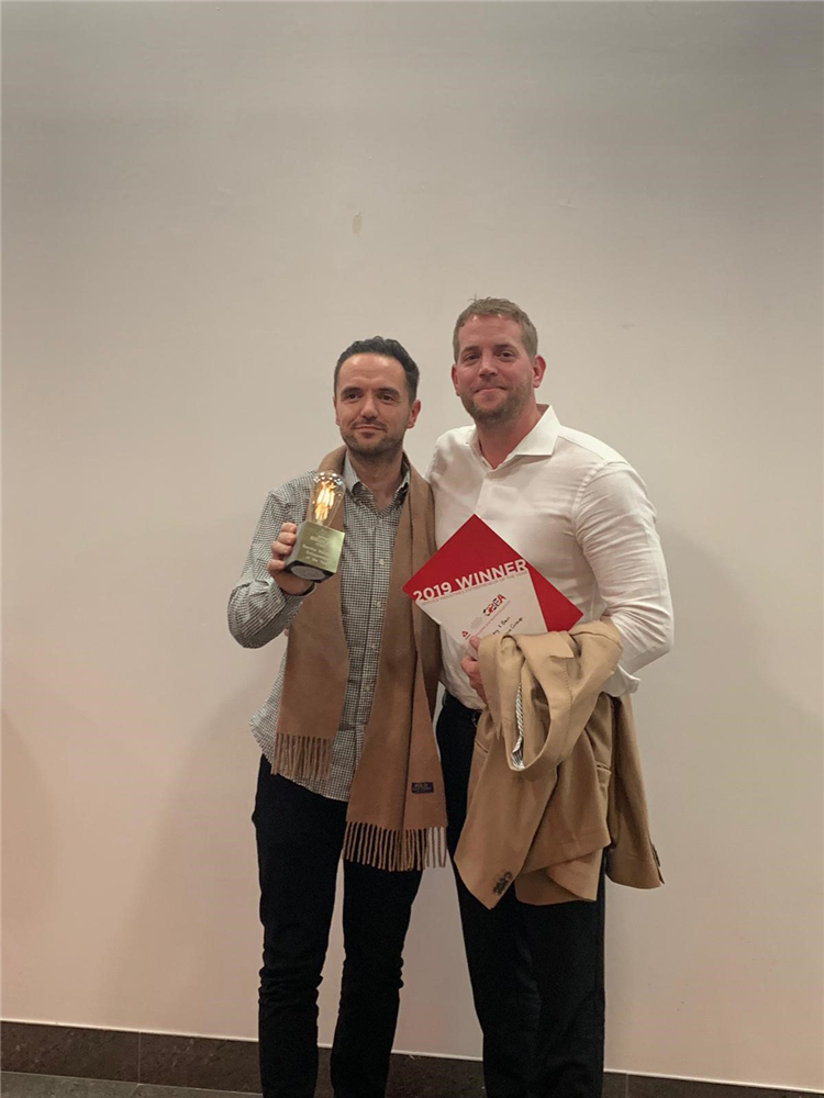 Two men with an award